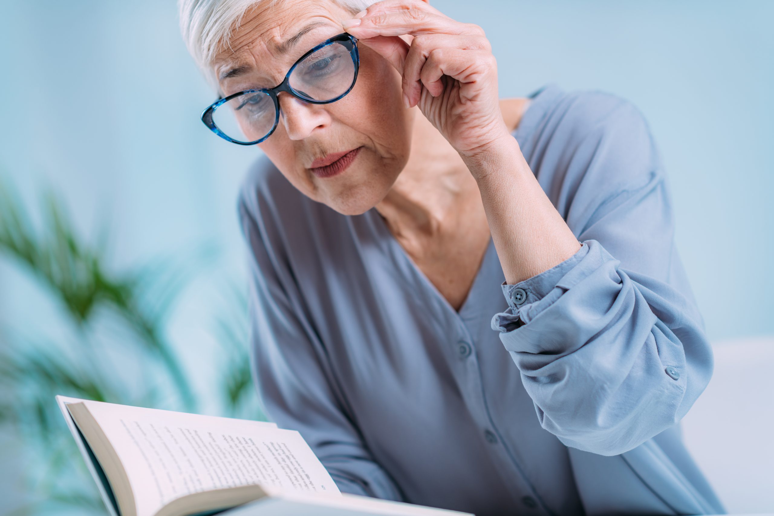 Glaucoma. Senior Woman a Reading Book